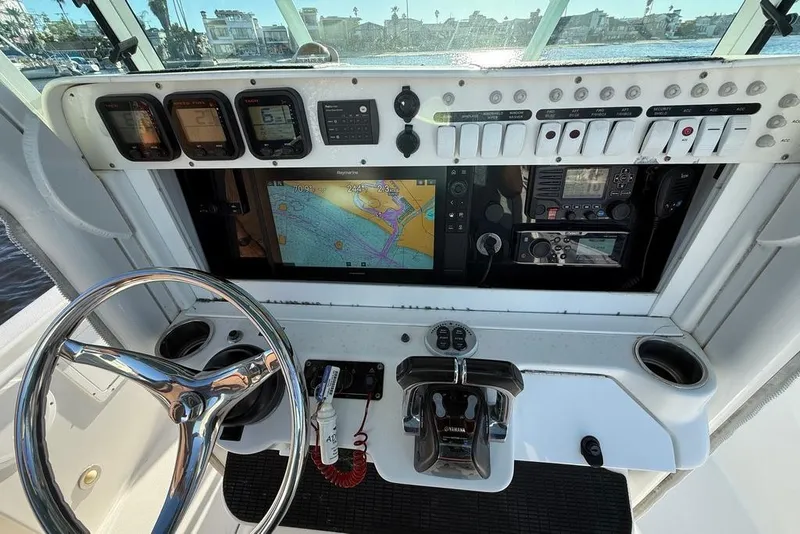 Slide: The Image of Dashboard of 2008 Everglades 290 Center Console boat with navigation and control systems. - 7