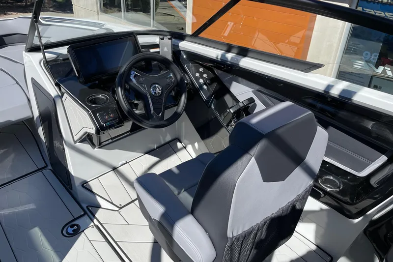 Slide: The Image of 2025 Yamaha Boats 255XD cockpit with modern steering wheel and dashboard controls. - 6