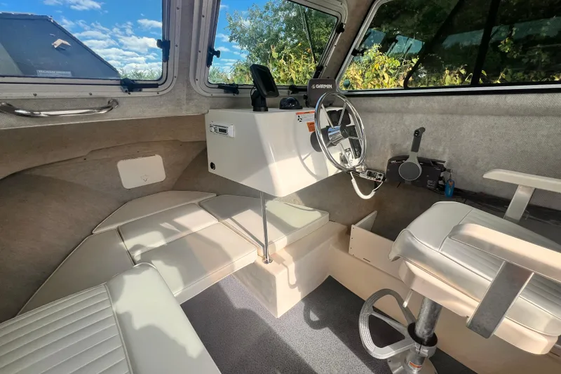 Slide: The Image of Interior of a 2007 Parker 2320 SL Sport Cabin boat with steering wheel and seating. - 4