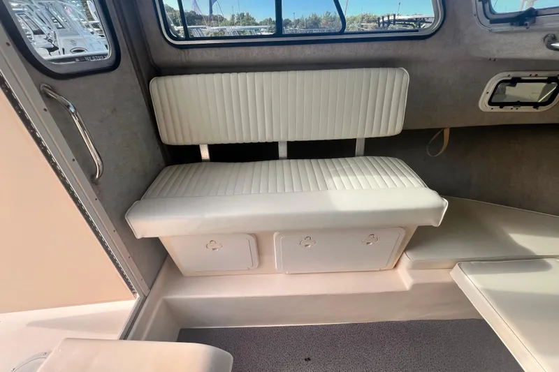 Slide: The Image of 2007 Parker 2320 SL Sport Cabin interior with white seating and storage compartments. - 5