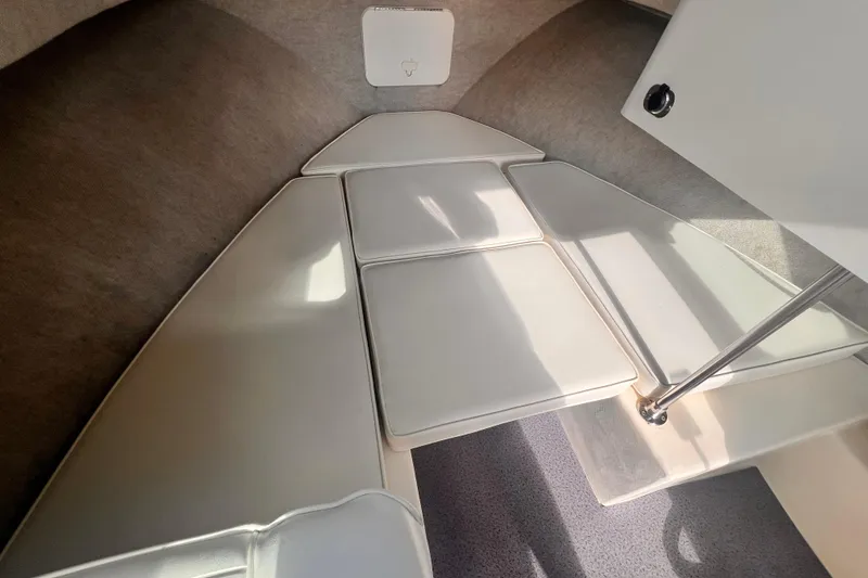 Slide: The Image of 2007 Parker 2320 SL Sport Cabin interior with cushioned seating and storage. - 6