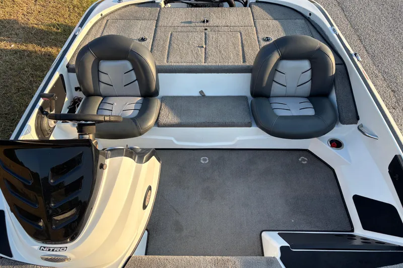 Slide: The Image of A person operates a 2016 Nitro Z18 Pro boat on a calm lake. - 13