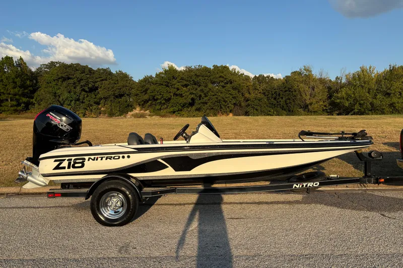 Slide: The Image of 2016 Nitro Z18 Pro boat on trailer by a lake. - 25