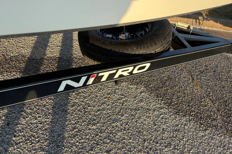 Slide: The Image of 2016 Nitro Z18 Pro boat on trailer, parked outdoors, with a powerful outboard motor. - 30