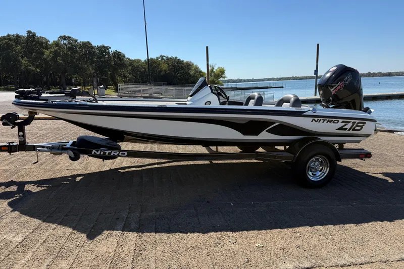 Slide: The Image of 2016 Nitro Z18 boat interior with gray seats and steering wheel. - 34
