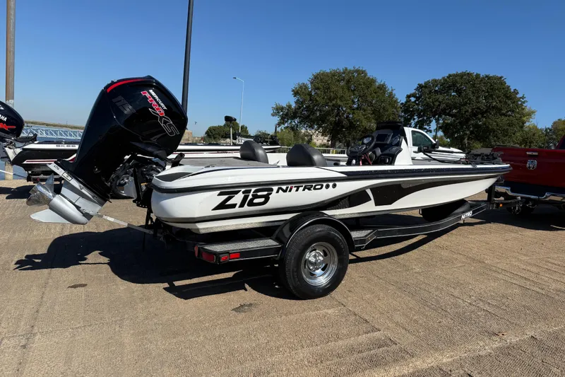 Slide: The Image of Mercury Pro XS 115 outboard motor on Nitro Z18 Pro, 2016 model, by a lake. - 43