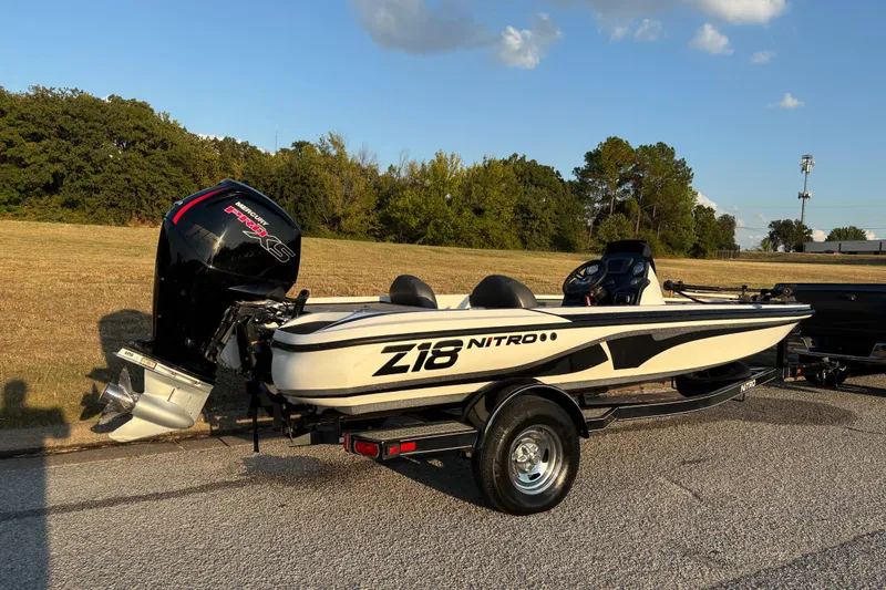 Slide: The Image of 2016 Nitro Z18 Pro boat on trailer by a lake under clear blue sky. - 5