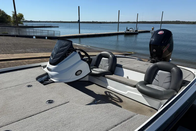 Slide: The Image of Open storage compartment on a 2016 Nitro Z18 Pro boat, featuring cup holders and hydraulic supports. - 53