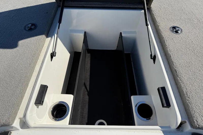 Slide: The Image of Front deck of a 2016 Nitro Z18 Pro boat with carpeted surface and storage compartments. - 56