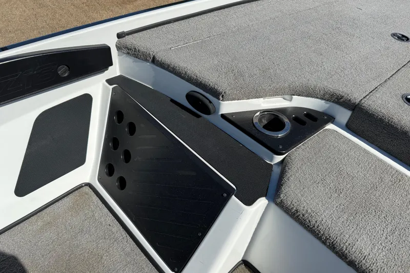 Slide: The Image of Empty storage compartment in 2016 Nitro Z18 Pro boat, with carpeted flooring and shoe visible. - 59