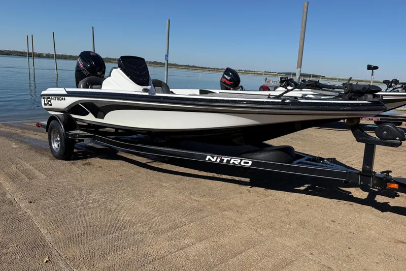 Slide: The Image of Black Nitro Z18 Pro boat trailer by the water, 2016 model. - 71