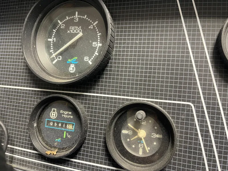 Slide: The Image of Dashboard gauges of a 1988 Sea Ray 268 Cruiser boat, showing RPM and engine hours. - 11