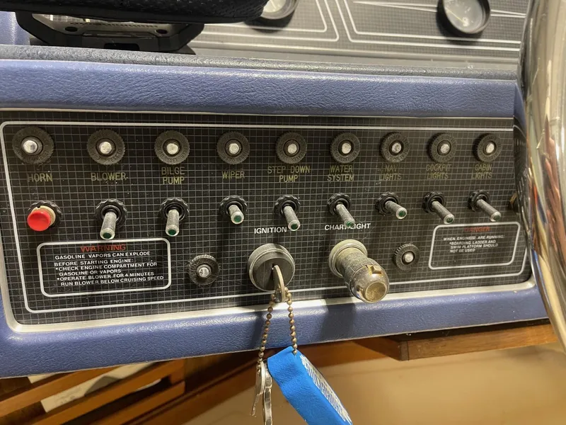 Slide: The Image of Control panel of a 1988 Sea Ray 268 Cruiser with ignition and various switches. - 12