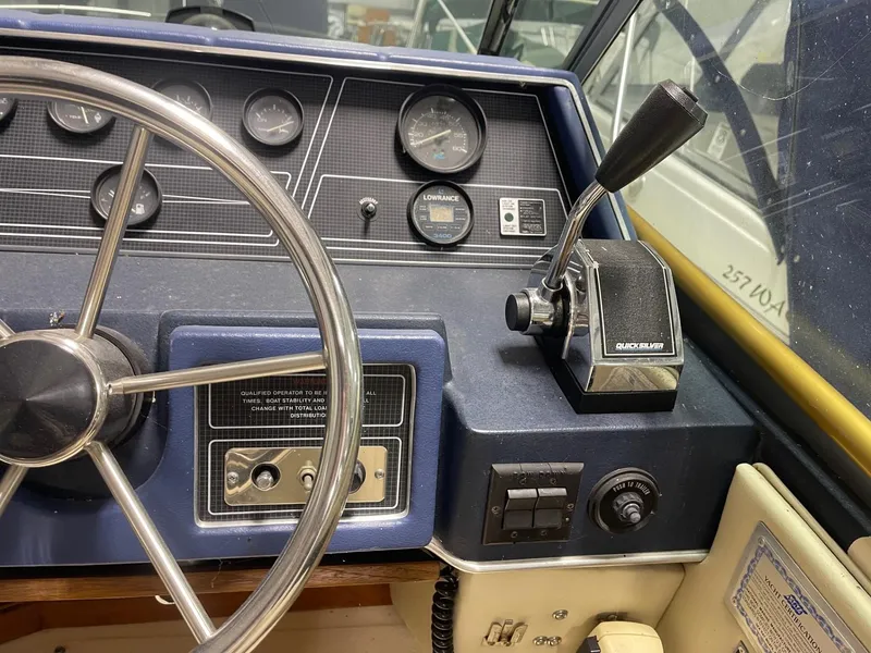 Slide: The Image of Dashboard of a 1988 Sea Ray 268 Cruiser with steering wheel and controls. - 14