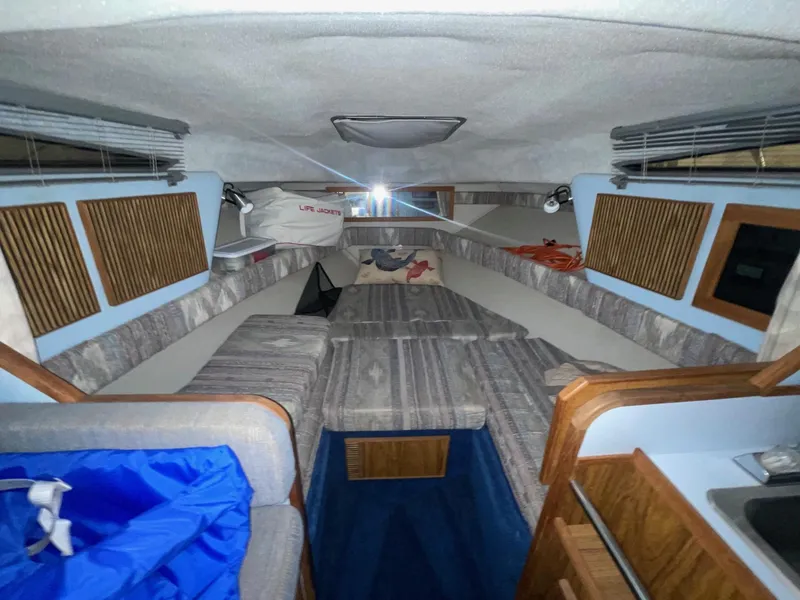 Slide: The Image of Interior of 1988 Sea Ray 268 Cruiser with cozy seating and wood accents. - 16