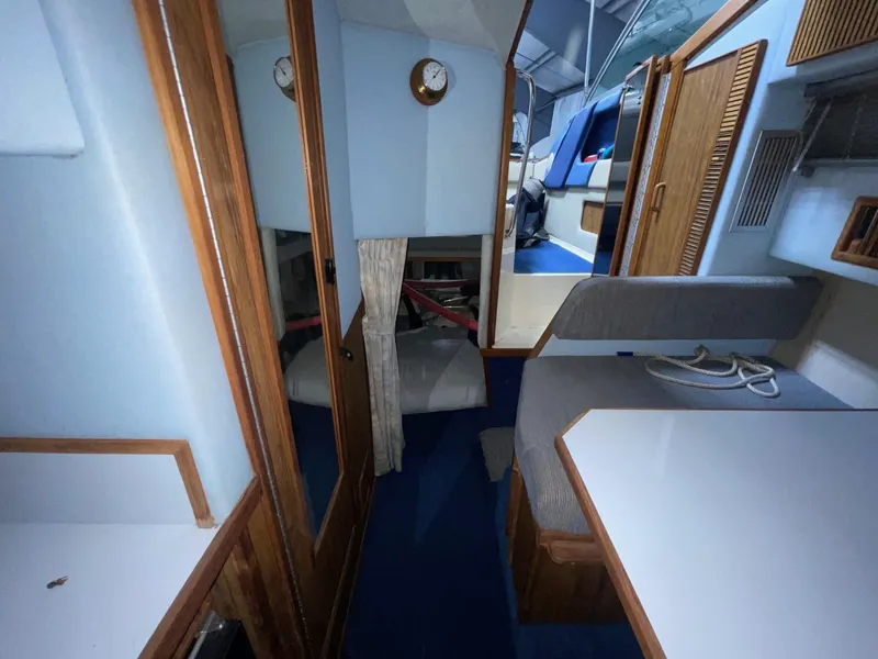 Slide: The Image of 1988 Sea Ray 268 Cruiser interior with blue carpet, wood accents, and seating area. - 21