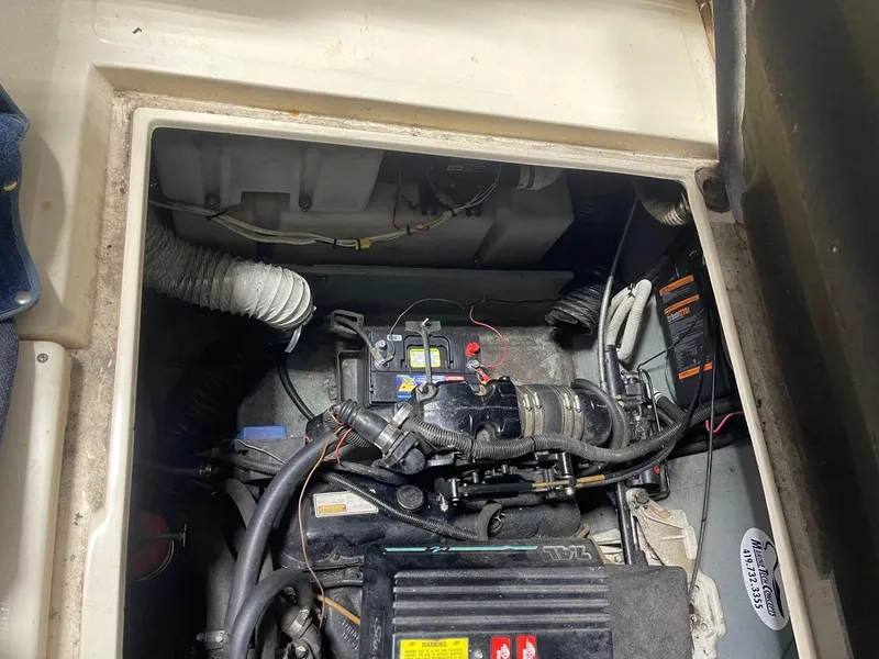 Slide: The Image of Engine compartment of a 1988 Sea Ray 268 Cruiser, showing mechanical components and wiring. - 24