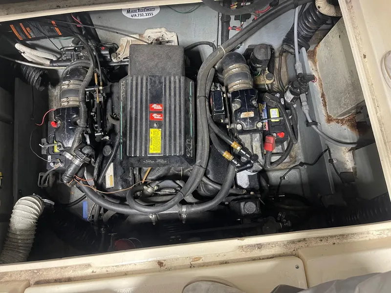 Slide: The Image of Engine compartment of a 1988 Sea Ray 268 Cruiser, showing dual engines and mechanical components. - 27