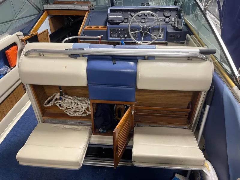 Slide: The Image of 1988 Sea Ray 268 Cruiser interior with steering wheel, seating, and storage compartments. - 6
