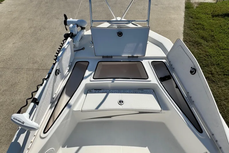 Slide: The Image of 2016 Blue Wave 2200 STL RISER boat deck with open storage compartments and trolling motor. - 20