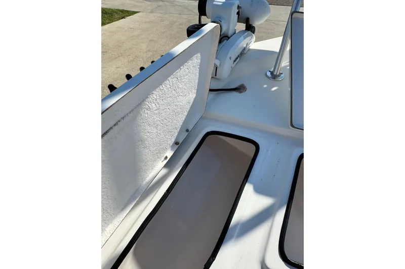 Slide: The Image of 2016 Blue Wave 2200 STL RISER boat deck with open storage compartments. - 23