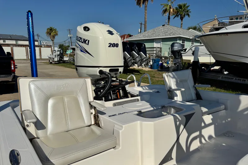 Slide: The Image of 2016 Blue Wave 2200 STL RISER boat with Suzuki 200 engine, parked outdoors. - 28