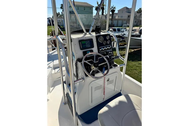 Slide: The Image of 2016 Blue Wave 2200 STL RISER boat console with steering wheel and navigation equipment. - 42