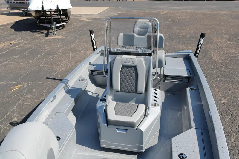 Slide: The Image of 2026 Xpress H20B Bay boat interior with seating and console, parked on asphalt. - 10