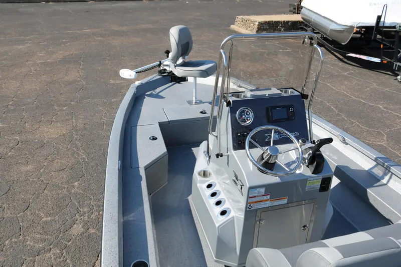 Slide: The Image of 2026 Xpress H20B Bay boat interior with white deck and black seating. - 13