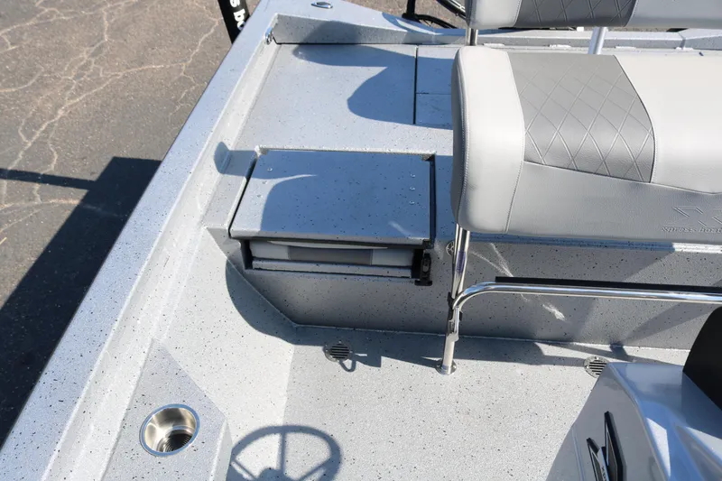 Slide: The Image of Open storage compartment on 2026 Xpress H20B Bay boat with cushioned seat. - 30