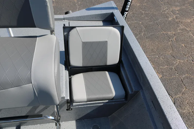 Slide: The Image of 2026 Xpress H20B Bay boat console with storage compartment and capacity warnings. - 34