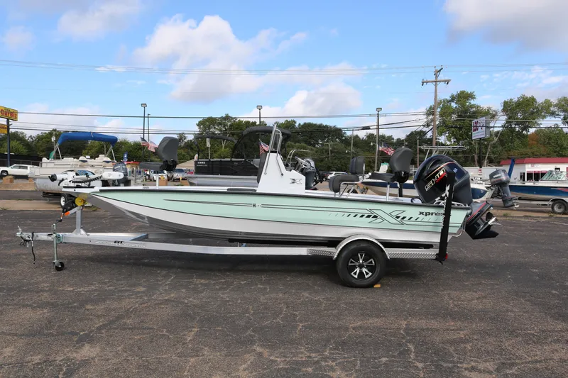 Slide: The Image of 2026 Xpress H20B Bay boat on trailer in outdoor dealership lot. - 4