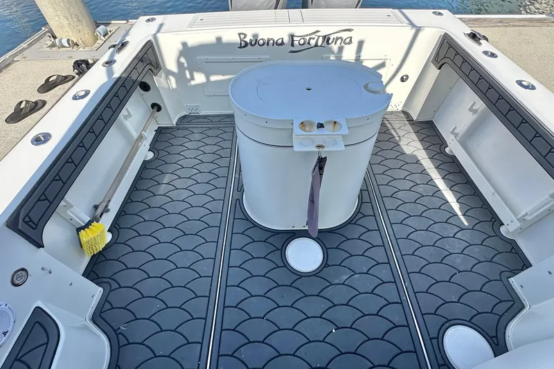 Slide: The Image of 2014 Parker 2530 Extended Cabin boat deck with non-slip flooring and storage compartments. - 11