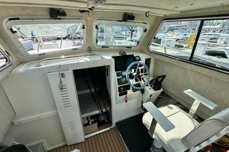 Slide: The Image of 2014 Parker 2530 Extended Cabin interior with steering wheel, control panel, and seating. - 16