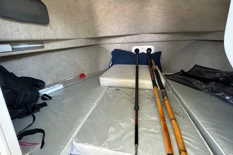 Slide: The Image of 2014 Parker 2530 Extended Cabin interior with fishing rods and gear. - 22