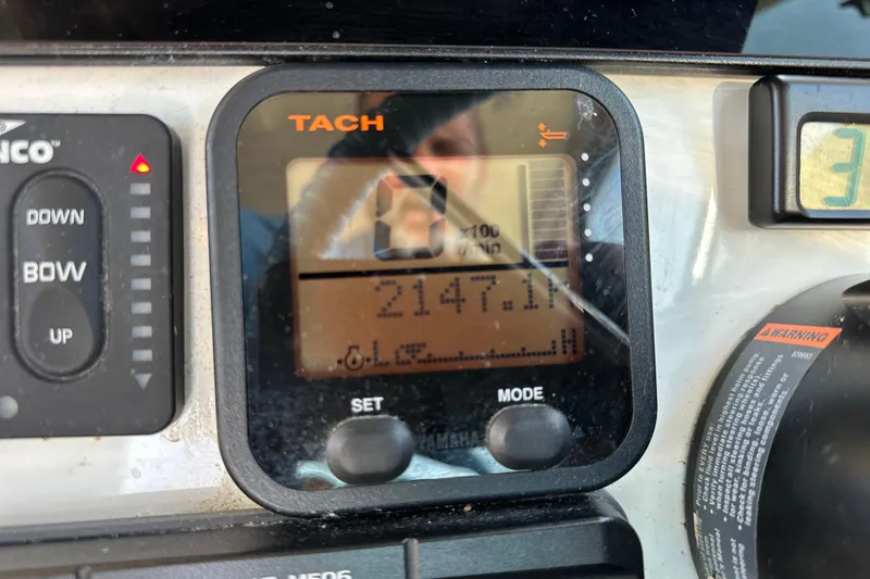 Slide: The Image of Close-up of a 2014 Parker 2530 Extended Cabin boat dashboard with tachometer display. - 24