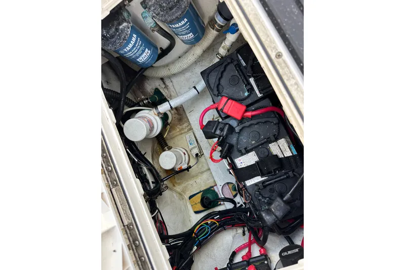 Slide: The Image of Engine compartment of a 2014 Parker 2530 Extended Cabin boat with batteries and wiring. - 25