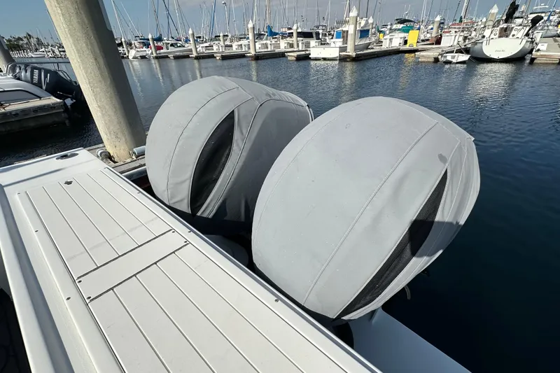 Slide: The Image of 2014 Parker 2530 Extended Cabin boat with covered engines at marina dock. - 8