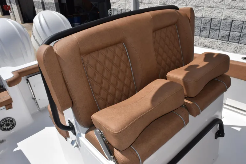 Slide: The Image of Luxurious seating on 2026 Sea Hunt Gamefish 27 boat, featuring brown cushioned upholstery. - 11