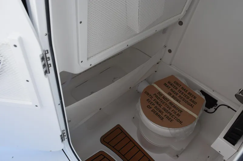 Slide: The Image of 2026 Sea Hunt Gamefish 27 Forward Seating boat interior with toilet and storage. - 20