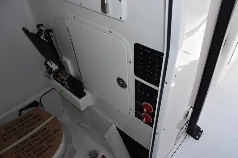 Slide: The Image of Interior of 2026 Sea Hunt Gamefish 27, featuring control panel and storage area. - 21
