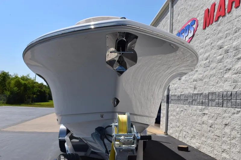 Slide: The Image of 2026 Sea Hunt Gamefish 27 Forward Seating boat on trailer, parked outside a marine store. - 3