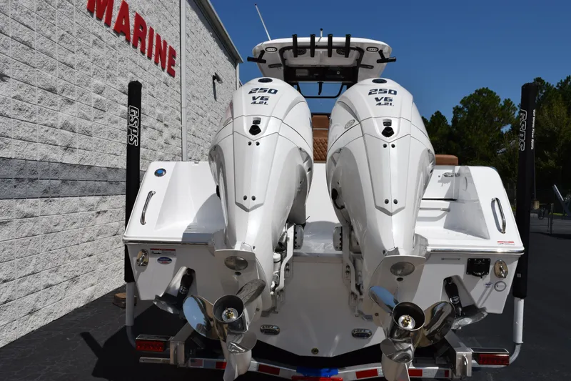 Slide: The Image of 2026 Sea Hunt Gamefish 27 with twin 250 V6 engines, displayed outdoors. - 5
