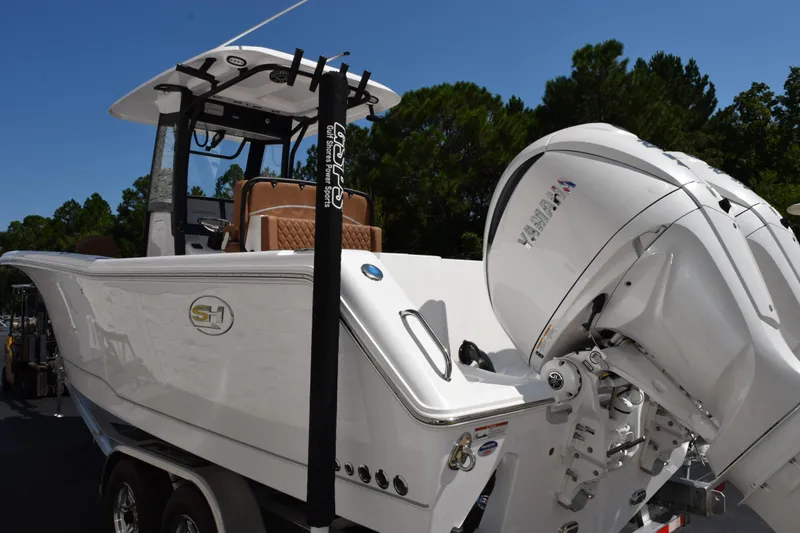 Slide: The Image of 2026 Sea Hunt Gamefish 27 boat with Yamaha outboard motor, parked on trailer. - 6