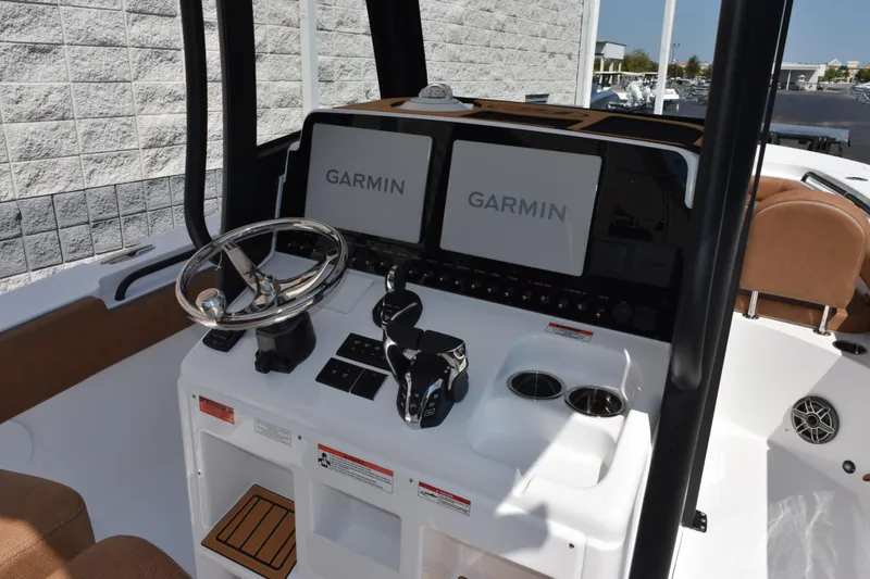 Slide: The Image of 2026 Sea Hunt Gamefish 27 helm with dual Garmin displays and modern controls. - 9