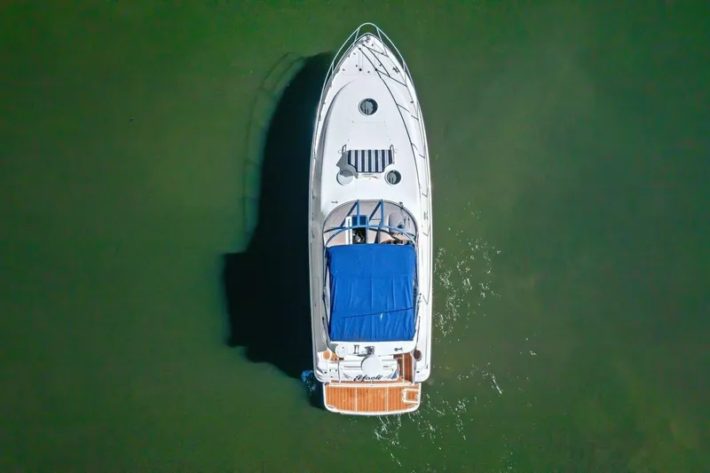 Slide: The Image of Aerial view of 2005 Regal Commodore 3560 yacht on calm green water. - 12