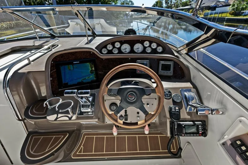 Slide: The Image of 2005 Regal Commodore 3560 boat dashboard with steering wheel and navigation instruments. - 14