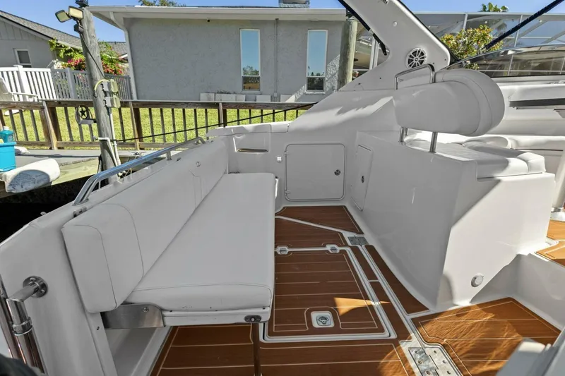 Slide: The Image of 2005 Regal Commodore 3560 boat interior with white seating and wooden flooring. - 20