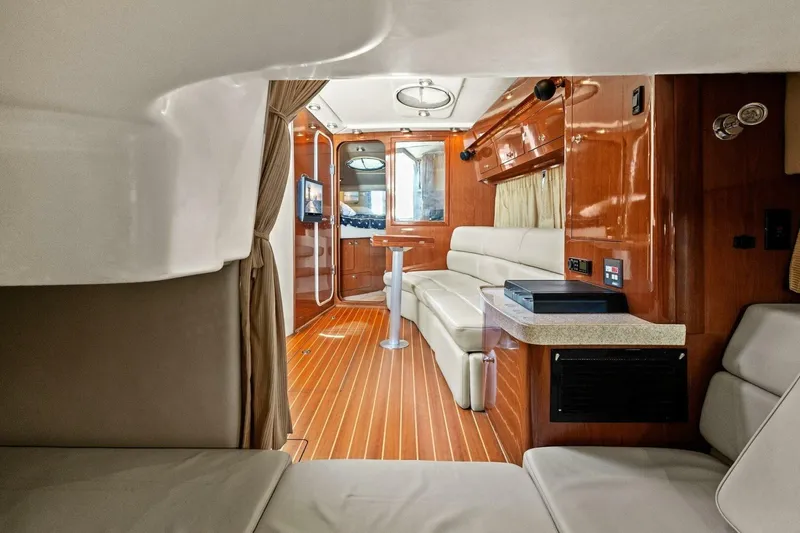 Slide: The Image of Luxurious interior of 2005 Regal Commodore 3560 yacht with wood accents and plush seating. - 27