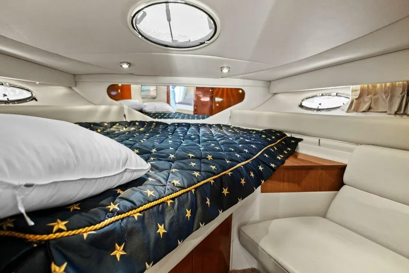 Slide: The Image of Luxurious cabin interior of 2005 Regal Commodore 3560 yacht with star-patterned bedding. - 29